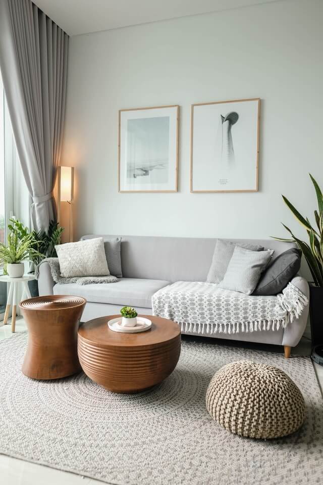 living room are with couch and coffee table. There is a rug on the floor and a fabric couch with have been services by Cairns Carpet Cleaners