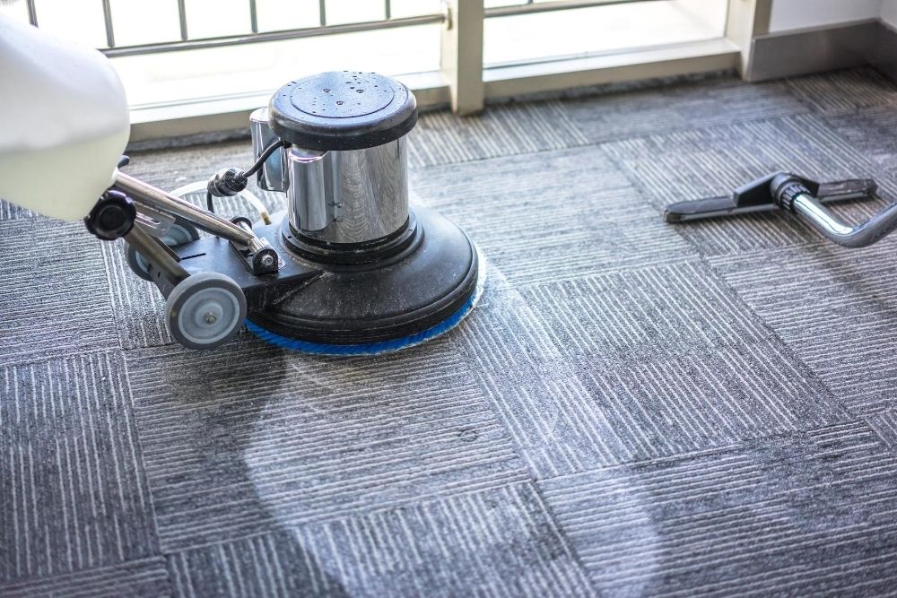 Rotating carpet cleaning machine being using on an apartment carpet for end of lease