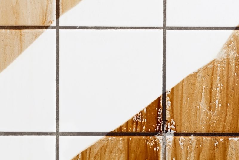 Wall of filthy tiles recently wiped clean