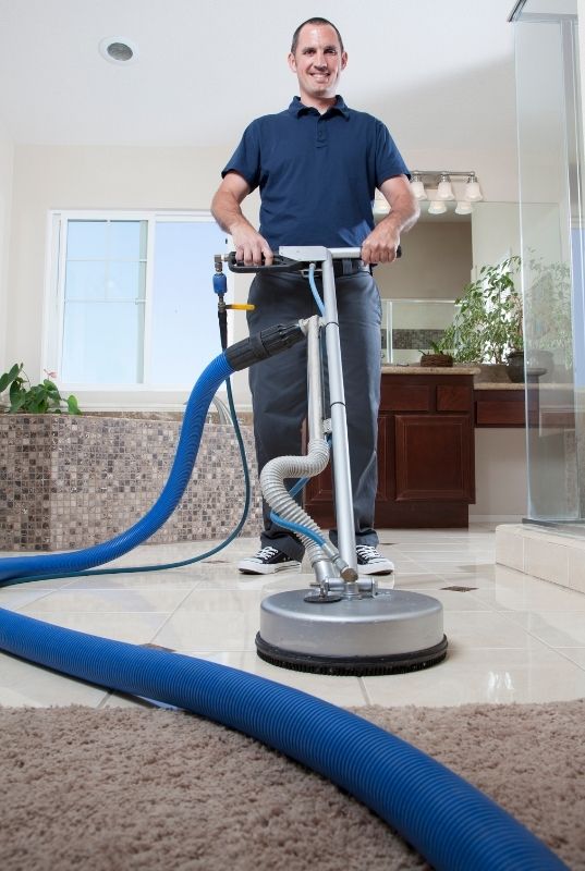 Person using a tile cleaning machine in a Cairns residential property